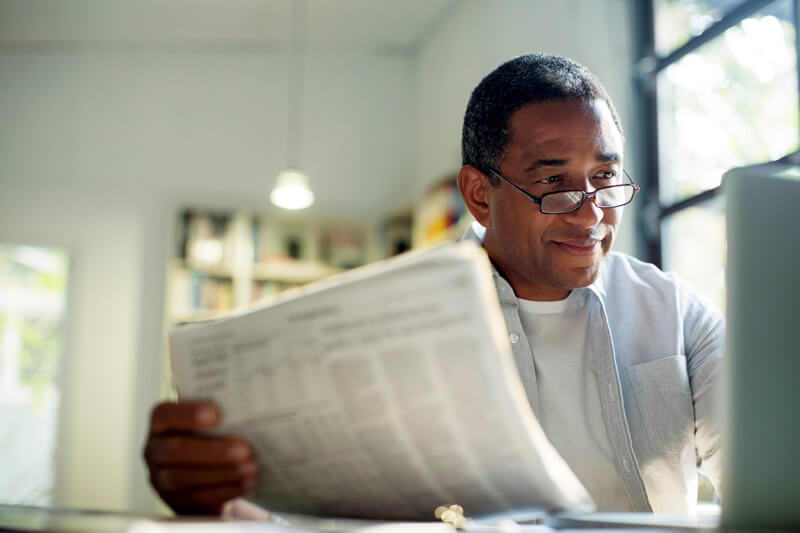 A man explores his Social Security benefits over coffee.
